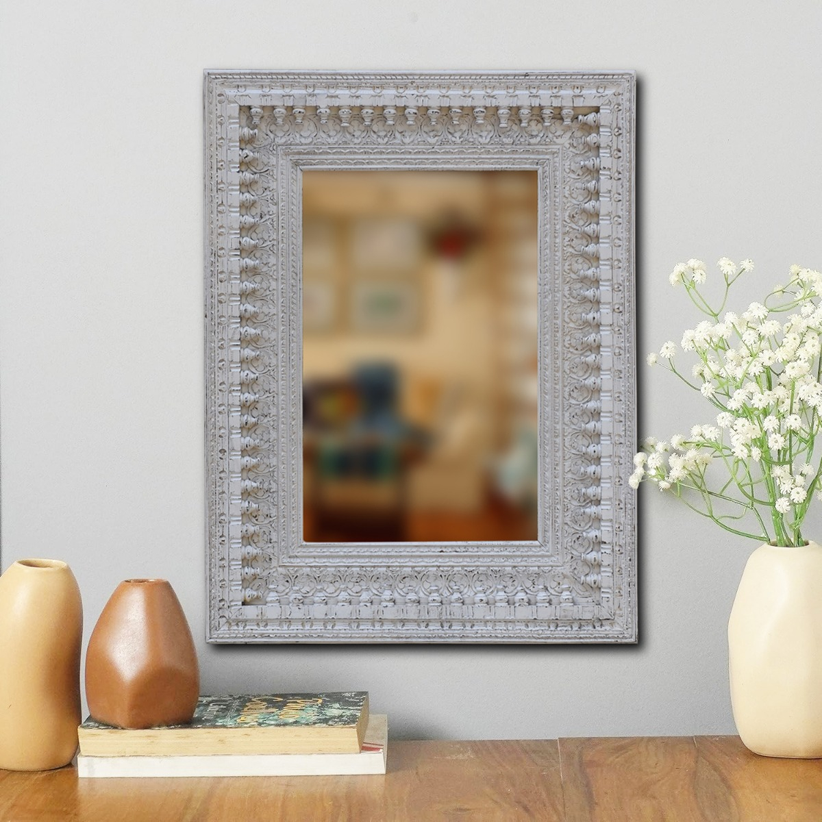 Ornate wooden mirror with rectangular carved frame design for classic decor
