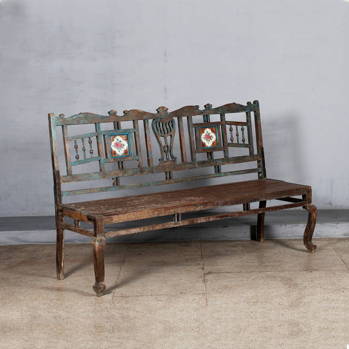 Rustic wooden bench with floral painted tiles on the backrest