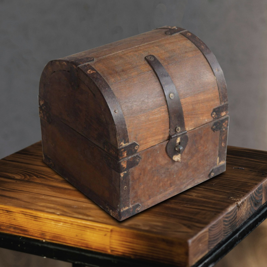 Front view of the Branikor wooden box with rustic multicolor finish and iron brass fittings on tabletop
