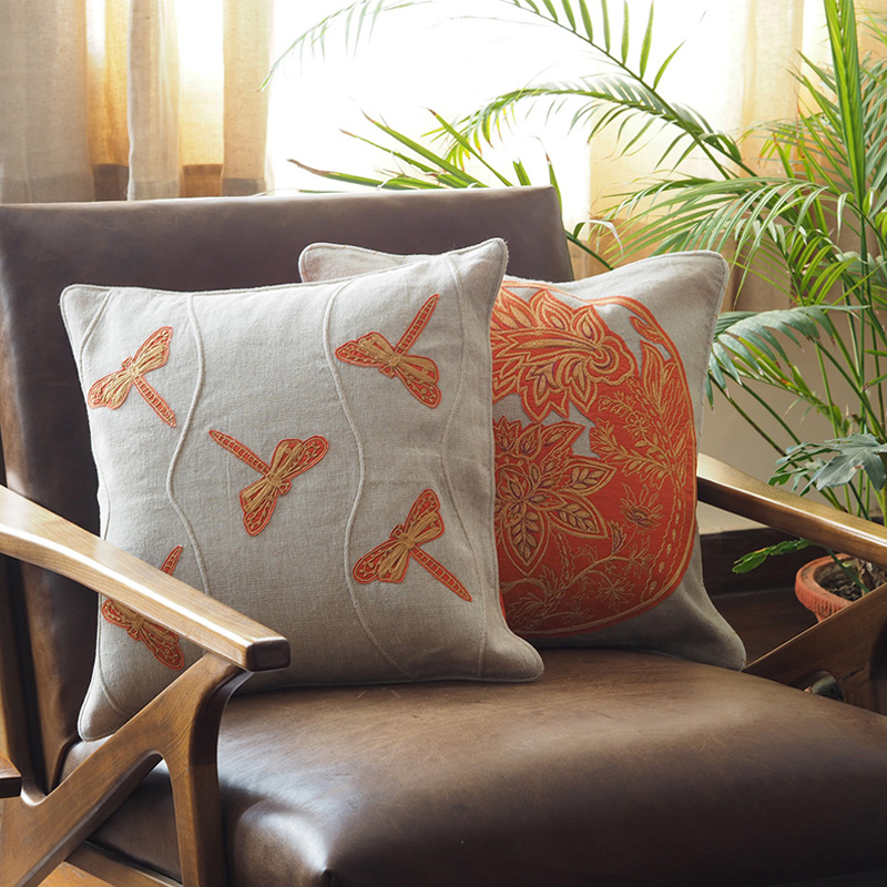 Stylish orange cushion covers for sofa with rich texture and decorative detailing