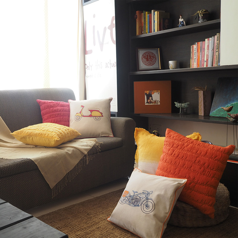 Colourful throw pillows arranged in a cozy living room space