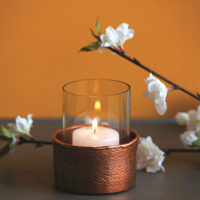 Copper votive candle holder with warm ambient glow