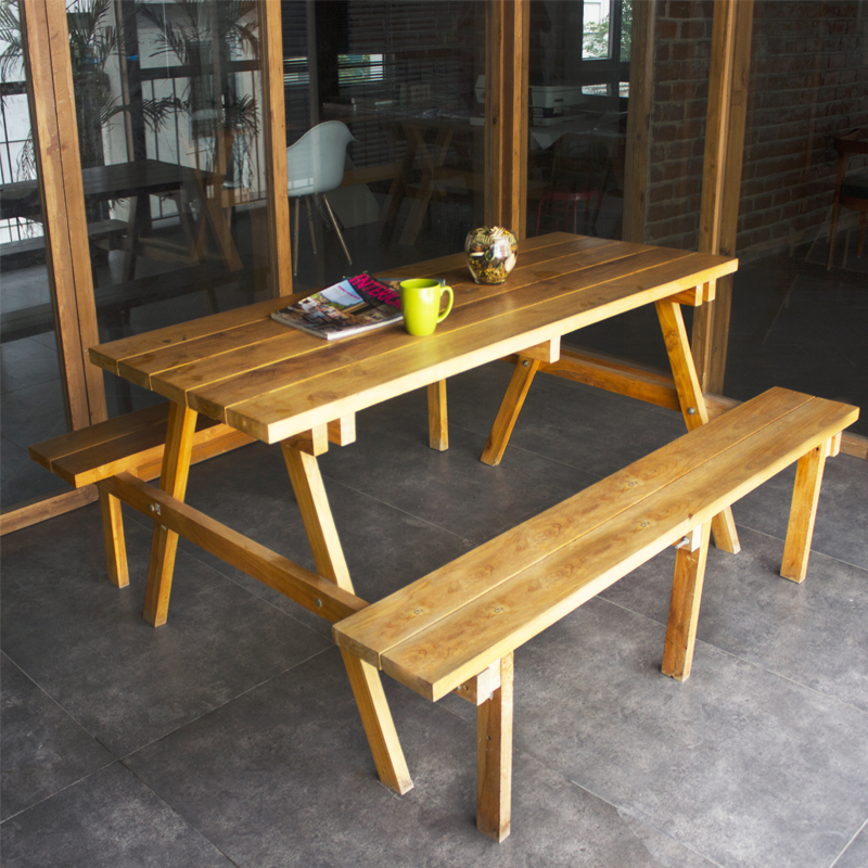 Natural wood table set with benches in modern indoor setting