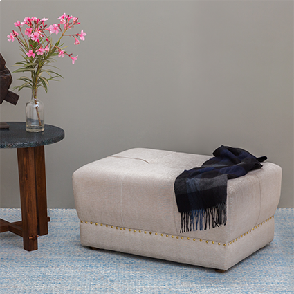 Tufted rectangular pouf ottoman adding a comfortable touch to modern living rooms